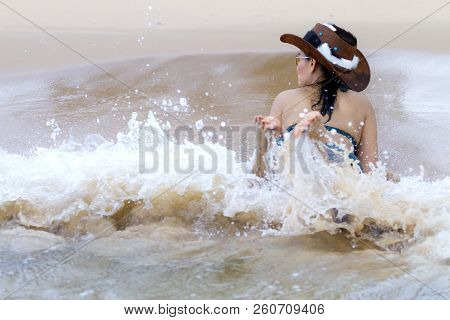 Woman With Bikini And Hat Play Wave On Beach At Bang Beot Beach, Chumphon Province Thailand
