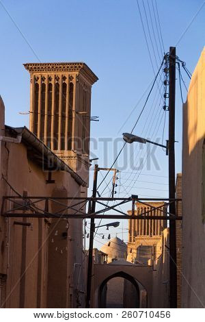 Typical Windtower Made Of Clay Taken In The Streets Of Yazd, Iran, Surrounded By Power Electrical Li