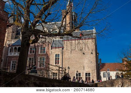 Bruges, Belgium - March, 2018: Bonifacius Bridge And The Building With The Smallest Window Of The Hi