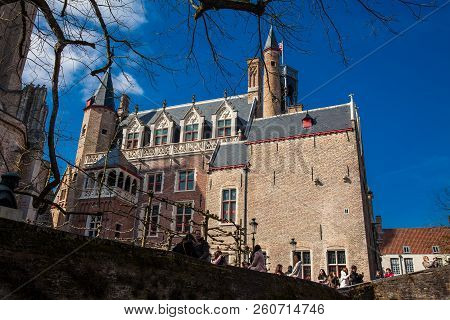 Bruges, Belgium - March, 2018: Bonifacius Bridge And The Building With The Smallest Window Of The Hi