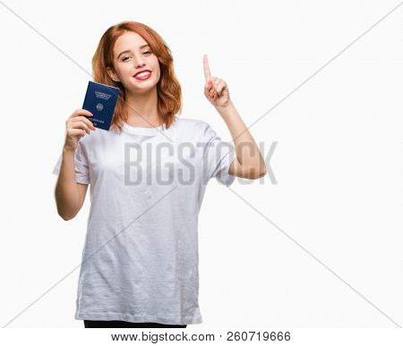 Young beautiful woman holding passport of germany over isolated background surprised with an idea or question pointing finger with happy face, number one