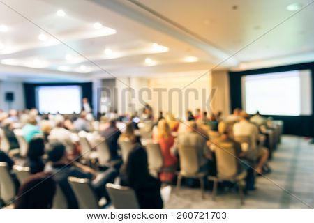 Blurry Background Speaker On Conference Stage With Dual Projectors In Usa