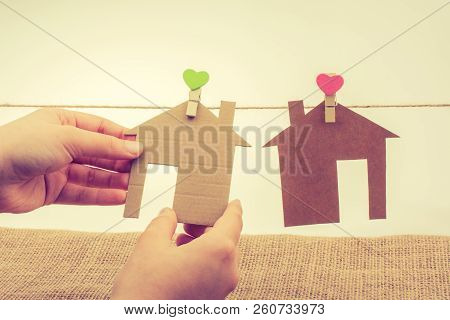 Hand Holding A Aper House On A Canvas Background
