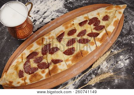 Turkish Pizza In The Form Of A Boat Is Called A Pied, Topped Baked Sudzhuk, Next To A National Drink