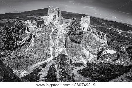 Ruins Of The Castle Gymes In Slovak Republic. Travel Destination. Panoramic Photo. Black And White P