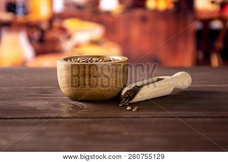 Lot Of Whole Fresh Brown Flaxseeds In A Scoop With Wooden Bowl With Rustic Wood Kitchen In Backgroun