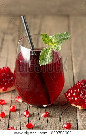 A Glass Of Pomegranate Juice With Fresh Pomegranate Fruits On Wooden Table. Vitamins And Minerals. H