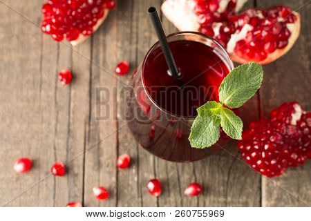A Glass Of Pomegranate Juice With Fresh Pomegranate Fruits On Wooden Table. Vitamins And Minerals. H