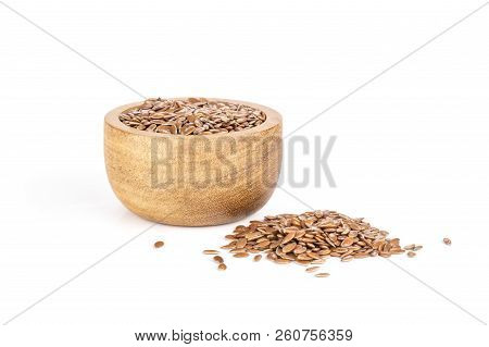Lot Of Whole Fresh Brown Flaxseeds With Wooden Bowl Isolated On White Background