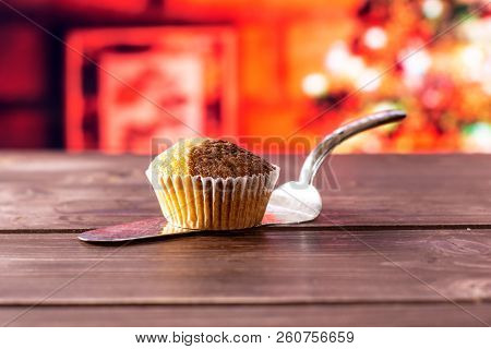 One Whole Fresh Baked Marble Muffin On Silver Cake Server With Christmas Tree In Red Background