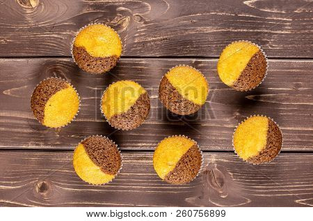 Group Of Eight Whole Fresh Baked Marble Muffin Flatlay On Brown Wood