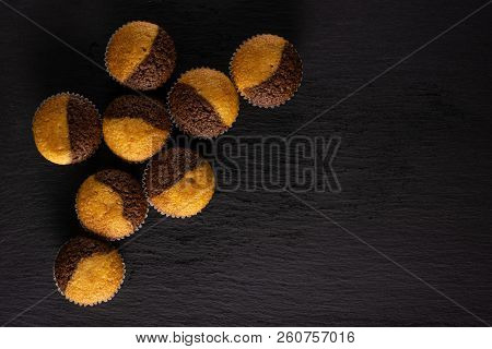 Group Of Eight Whole Fresh Baked Marble Muffin Flatlay On Grey Stone