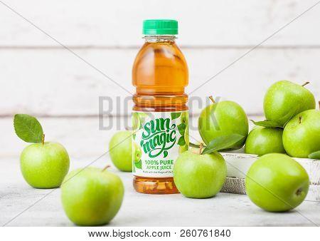 London, Uk - September 13, 2018: Bottle Of  Sun Mgic Apple Juice With Fresh Apples In Box On Wood Ba