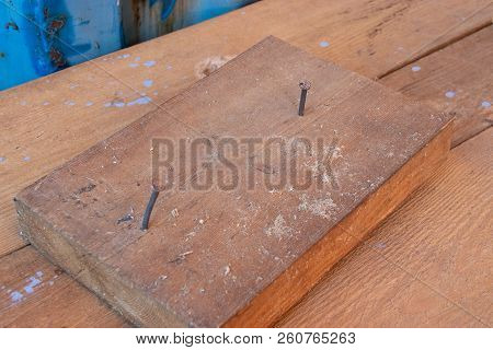 Wooden Block With Two Nails In Workshop Cabinetry Repair Work Bench With Blue Wall