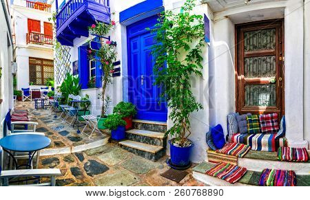 Traditional narrow streets with cute cafe bars in Greece. Skopelos island, Sporades