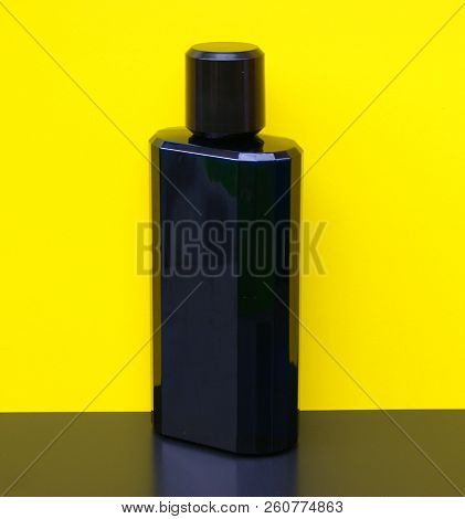 Eau De Toilette, Large Perfume Bottle In Front Of Yellow Background