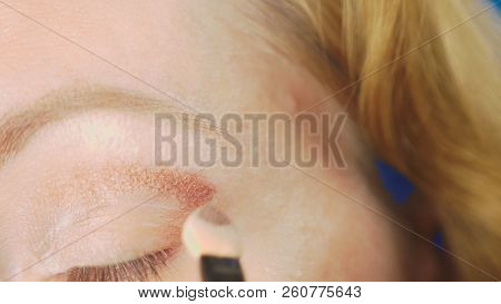 Super Close-up, A Woman Doing Her Eye Make-up, Paints The Eyelid With Shadows.