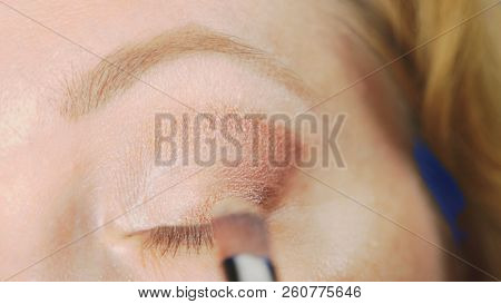Super Close-up, A Woman Doing Her Eye Make-up, Paints The Eyelid With Shadows.