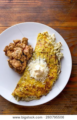Venezuelan Food. Corn Cachapa With Cheese And Fried Pork - Cochino Frito. Wooden Background, Top Vie