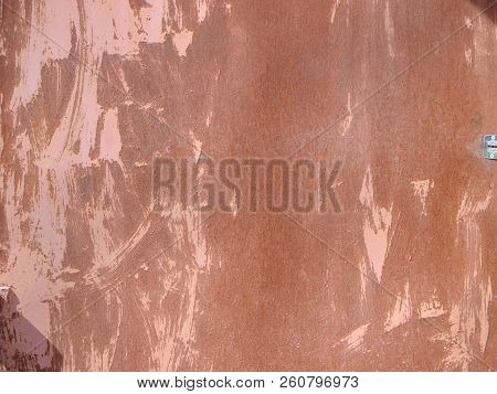 The Background Is A Textured Sheet Metal With Paint And Rust