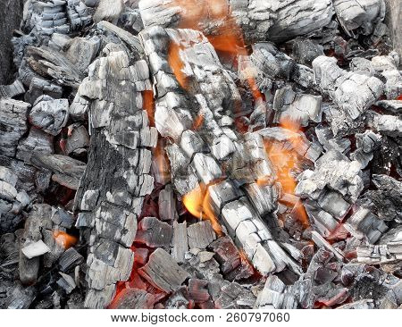 Beautiful Red Flame From Slice Wood, Dark Grey Black Coals Inside Metal Brazier. Wood Burning In The