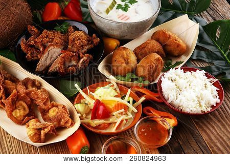 Chines Food With Fried Duck With Curry Sauce. Tom Kah Kai Soup, Dumplings And Rice. Fried Banana And