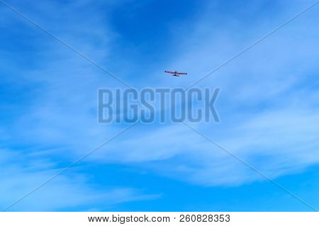 Glider In The Sky, A Small Aircraft Soars In The Blue Sky