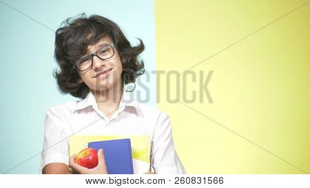Portraits Of A Teenage Boy In School Uniform On A Colored Background. Funny Guy. Concept Of Learning