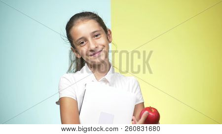 Portraits Of A Teenage Girl In School Uniform On A Colored Background. Funny Girl. Concept Of Learni