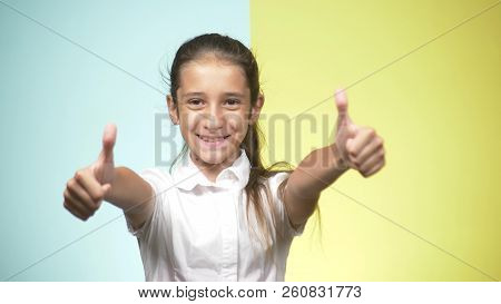 Portraits Of A Teenager In School Uniform On A Colored Background. Concept Of Learning. The Teenager