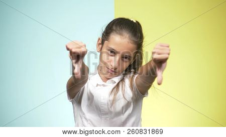 Portraits Of A Teenager In School Uniform On A Colored Background. Concept Of Learning. The Teenager
