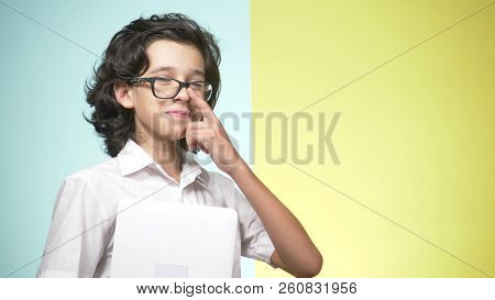 Portraits Of A Teenager In School Uniform And Glasses On A Colored Background. Funny Guy. Concept Of