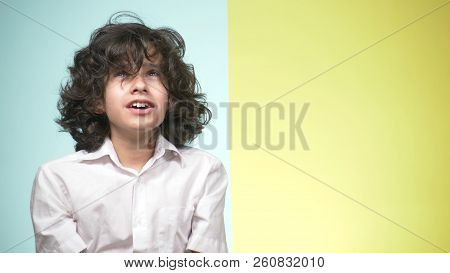 Portraits Of A Teenager In School Uniform And Glasses On A Colored Background. Concept Of Learning. 