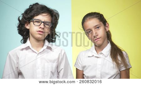 Portraits Of Children In School Uniform On A Colored Background. Funny Children. Sister And Brother.