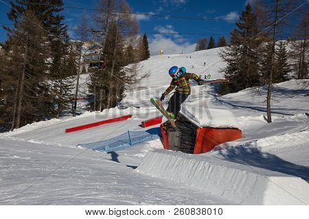 Skier In Action: Ski Jumping In The Mountain Snowpark.