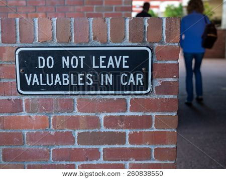 People Walking Away From Do Not Leave Valuables In Car Sign