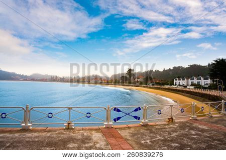 Ribadesella beach in Asturias with white railing in Spain