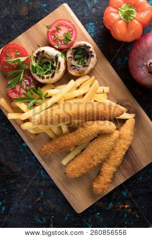Deep fried chicken frites with potato chips or french fries