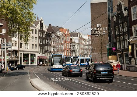 Amsterdam, Netherlands - May 6, 2013: City Life On Nieuwezijds Voorburgwal Street In The Heart Of Th