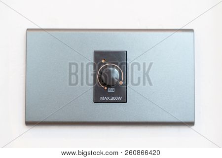 Close Up Hand Turning On Grey Dimmer Switch