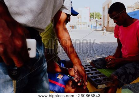 Palmeira, Sal Island, Cape Verde - Jan 5 2016: Local Villager Man Playing Ouril Game At The Main Squ