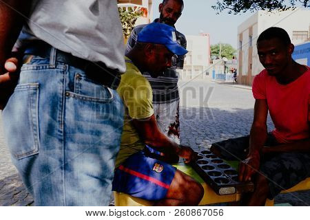 Palmeira, Sal Island, Cape Verde - Jan 5 2016: Local Villager Man Playing Ouril Game At The Main Squ