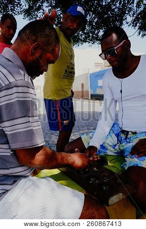 Palmeira, Sal Island, Cape Verde - Jan 5 2016: Local Villager Man Playing Ouril Game At The Main Squ