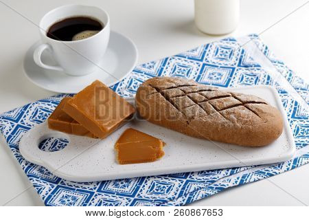Norwegian breakfast with Brunost cheese, bread, and coffee