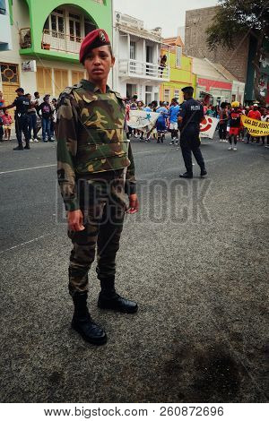 Mindelo, Sao Vicente Island, Cape Verde - Jan 5 2016: A Young Police Woman Wathes The Dancing Carniv