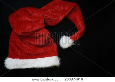 Christmas Decoration With Place For Greeting On Chalk Blackboard. Santa Claus Hat And Gift Boxes