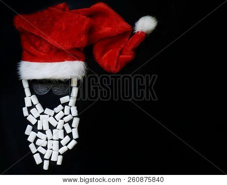 Painted With Chalk Santa Claus With A Real Red Cap And A Beard Of Marshmallow On The Slate, The Conc
