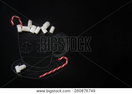 A Chalk-drawn Mug Of Hot Chocolate With A Real Candy Cane And Real White Marshmallows On A Chalkboar