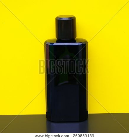 Eau De Toilette, Large Perfume Bottle In Front Of Yellow Background