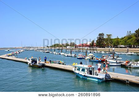 Olhau, Portugal - June 12, 2017 - View Of Boats And Yachts Moored In The Marina With The Promenade (